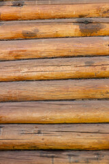 Fototapeta premium Textured wooden logs arranged in a horizontal pattern showcasing natural colors, grain, and rustic charm