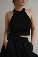 Black Crop Top and High-Waisted Pants Front Pose. Confident Look Featuring Classic Black Top and...