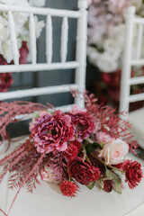 A beautiful close-up of delicate pastel pink flowers, including roses and peonies, captured in soft natural light.