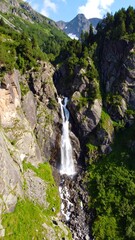 Mountain waterfall cascading down rocky slopes