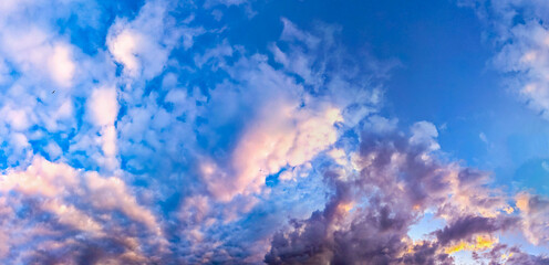 Mesmerizing sunset landscape over the river, reflecting orange reflect light in the water. Blue sky with some clouds. Dark cloud summer skies, Cloudy and clear air with copy space.