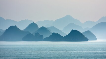 Tranquil seascape with calm waters leading to distant misty mountains,