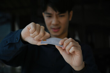 Symbolic act of financial freedom, Close-up shot of a man fighting back against overwhelming credit debt.