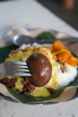 Gudeg Telor, captured on September 1, 2025. Traditional Javanese dish of young jackfruit stew served with hard-boiled egg, rich brown coconut milk sauce, authentic Indonesian culinary heritage