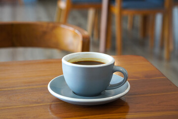 Hot Americano Coffee, captured on September 1, 2025. Steaming black coffee served in white ceramic cup on wooden table, cozy minimalist style, perfect for café, breakfast, and lifestyle themes