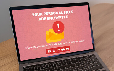 Laptop screen infected by ransomware demanding a payment to decrypt files. Cybersecurity threat,...
