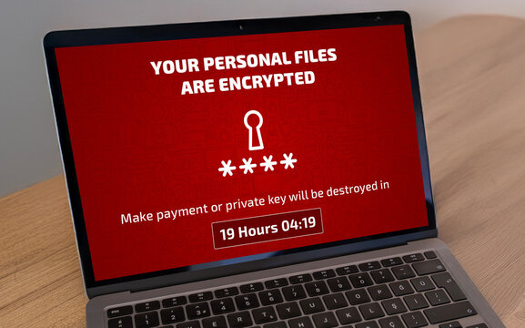 Laptop screen infected by ransomware demanding a payment to decrypt files. Cybersecurity threat, hacking, and data extortion concept.