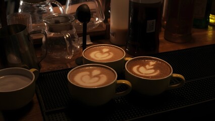 Three Yellow Cups of Coffee with Latte Art