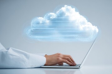 Hands typing on laptop, cloud graphic overlay (1)