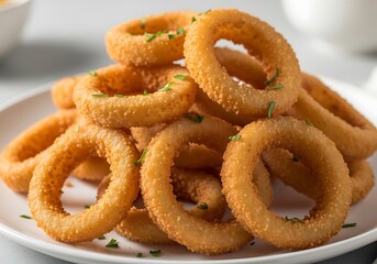 Close up of a stack of golden brown, crispy battered onion rings, a classic and popular deep-fried snack or side dish