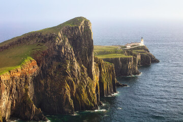 A view of the Neist Point Lighthouse on the green cliffs of the Isle of Skye