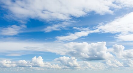 Fototapeta premium A serene blue sky filled with fluffy white cumulus clouds, creating a peaceful and dreamy atmosphere, a beautiful and calming natural backdrop