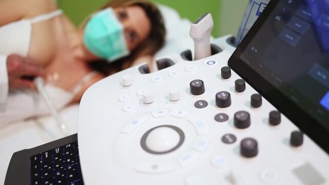 Cardiologist performing an echocardiogram on a female patient wearing a surgical mask, using ultrasound technology to assess heart health in a modern clinic
