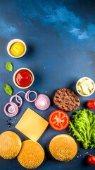 Overhead view of hamburger ingredients on a dark blue surface