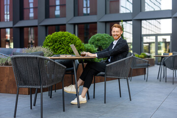 Young adult professional working on computer outdoor
