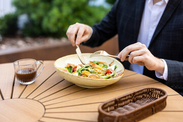 Unrecognizable professional in suit having lunch break