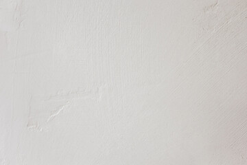 Smooth white wall surface texture with subtle variations and natural light reflections