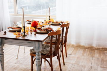 Cozy autumn dining table set up with seasonal decorations and a warm ambiance