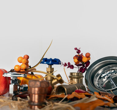 Plumbing service concept with tools and autumn leaves with copy space at the top.