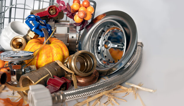 Plumbing tools with small pumpkins and festive Thanksgiving elements.