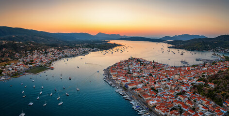 Aerial view of the town of Galatas and the oposite Poros island in the Saronic Gulf, Greece, during summer sunset time