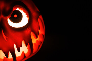 Sinister glowing pumpkin shines with fear, carved for Halloween horror tradition.