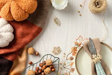 Elegant autumn table setting with plush pumpkins, rustic napkin decor, nuts, and warm-toned fabric. Perfect for Thanksgiving, harvest celebration