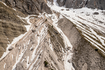 Snowy slopes and rocky peaks of the Dolomites mountains in Italy.