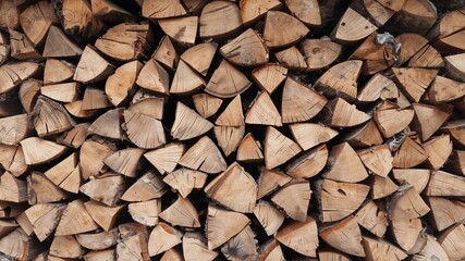 Neatly Stacked Firewood Logs Ready for Winter, Showing Wood Grain and Texture.
