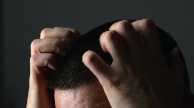 An adult man scratches his head with his hands because of scalp problems and dandruff.
Eczema and psoriasis bother a man with a short haircut.
Itchy scalp