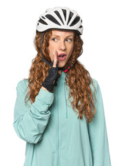 Young redhead cycling in studio is saying a secret hot braking news and looking aside