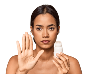 Filipino woman holds deodorant in studio standing with outstretched hand showing stop sign, preventing you.