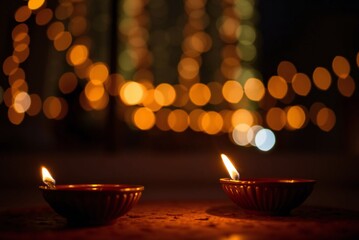 Diwali diyas with bokeh lights 