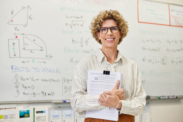 Portrait of confident female teacher smiling at camera
