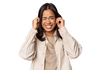 Portrait of a young Filipino woman covering ears with hands.