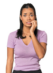 Young Filipina woman biting fingernails, nervous and very anxious.