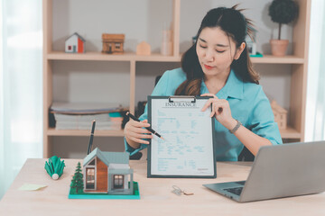 House selling ideas, online consultation with Asian women Real estate concept with wooden house...