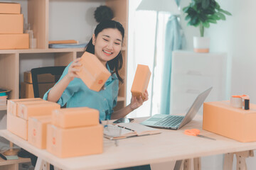 Small business startup. SME owner. Female entrepreneur checks online orders to prepare to pack...