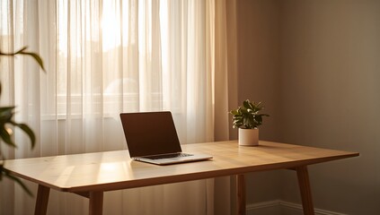Fototapeta premium A laptop sits on a wooden desk in front of a window