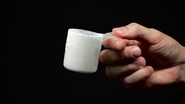 Dry freeze-dried protein in a measuring cup close-up.
Scoop of protein or creatine for athletes.
Protein concentration in the body.
Dry processed protein in a measuring spoon
