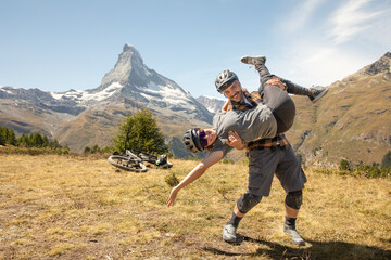 Playful Biking Couple Posing in Alps with Matterhorn in Background