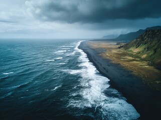 Fototapeta premium Dramatic coastal scene, dark sand beach meeting the stormy sea