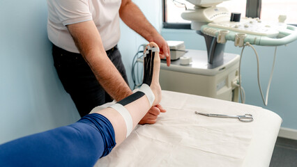 Male physiotherapist assisting with ankle rehabilitation exercise