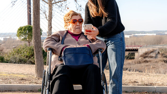 Grandmother and granddaughter sharing a moment outdoors