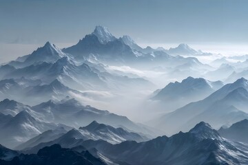 Obraz premium Majestic snow-capped mountains in misty blue hues.