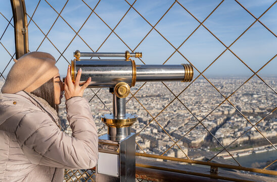 Woman viewing Paris from the Eiffel Tower in the morning