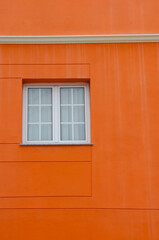 Modern style architecture detail window at bright orange wall ,perfect aesthetic for reels, design inspiration, or travel storytelling.