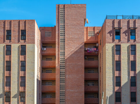 Brick apartment buildings under clear blue sky