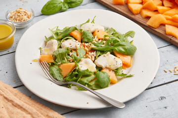 Mozzarella melon arugula salad