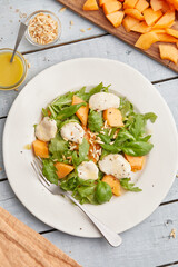 Mozzarella melon arugula salad